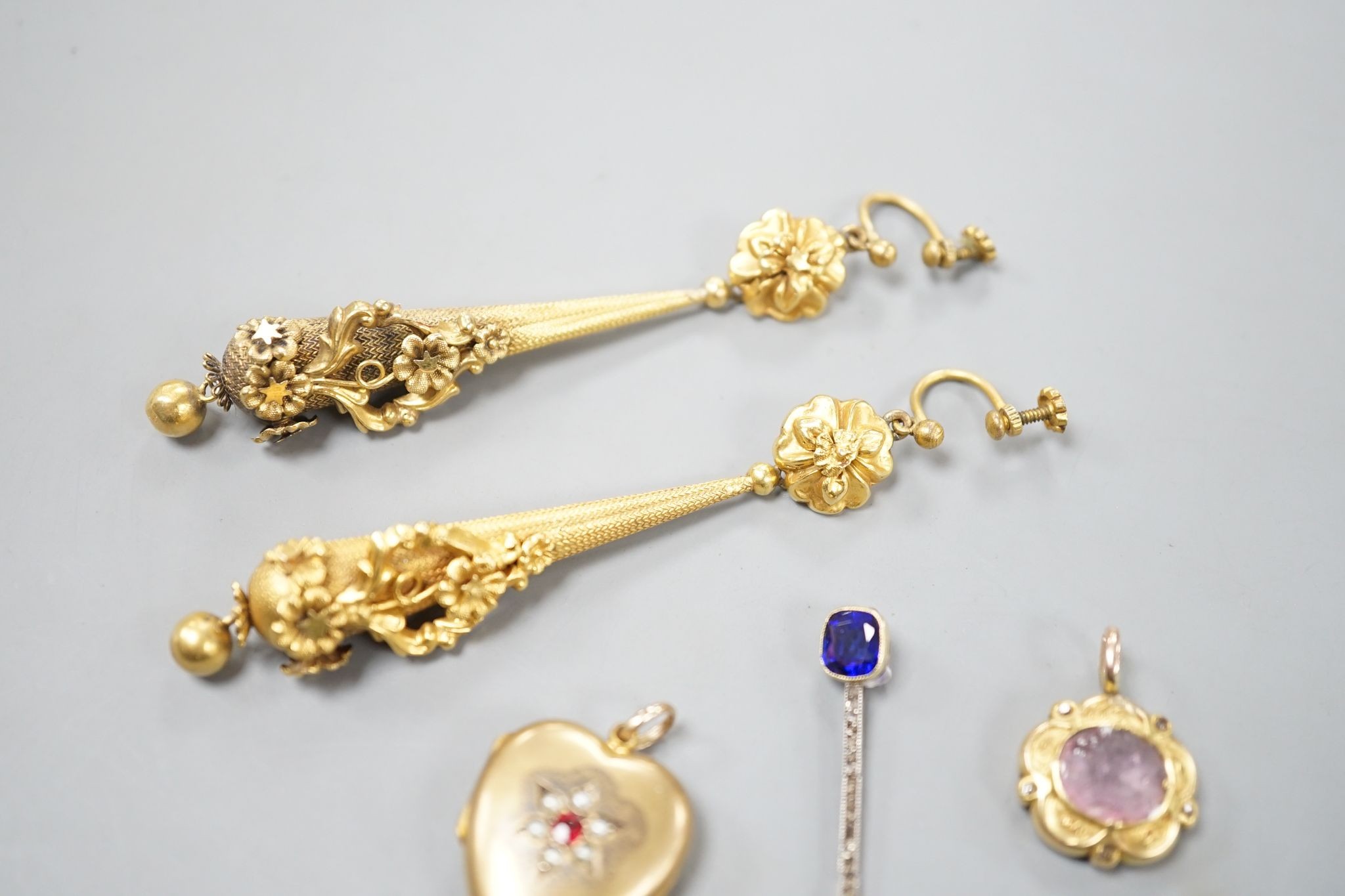 A pair of yellow metal drop earrings, overall 89mm, a simulated sapphire pendant and two other pendants.